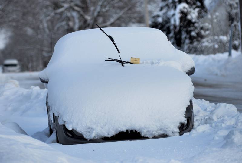 A car covered in snow sits along a street in Mt. Morris with a ticket on its windshield on Saturday, Jan. 13, 2024. Friday's winter storm dumped 10-12 inches of snow on the village and left many residents still digging out over the weekend.