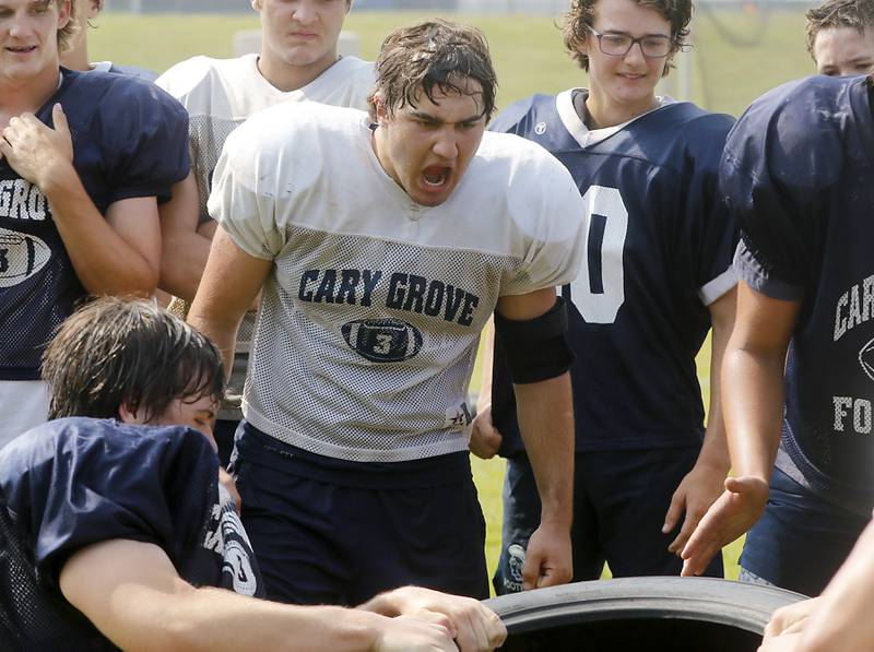 Cary-Grove’s Will Barcy cheers on his teammates during football practice Thursday, June 29, 2022, at Cary-Grove High School in Cary.