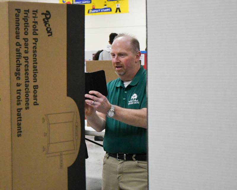 Michael Krugman the principle of Whittier School in Downers Grove takes a photograph of a science project during the school district 58 science fair held at O’Neill Middle School on Saturday Jan. 20, 2024.
