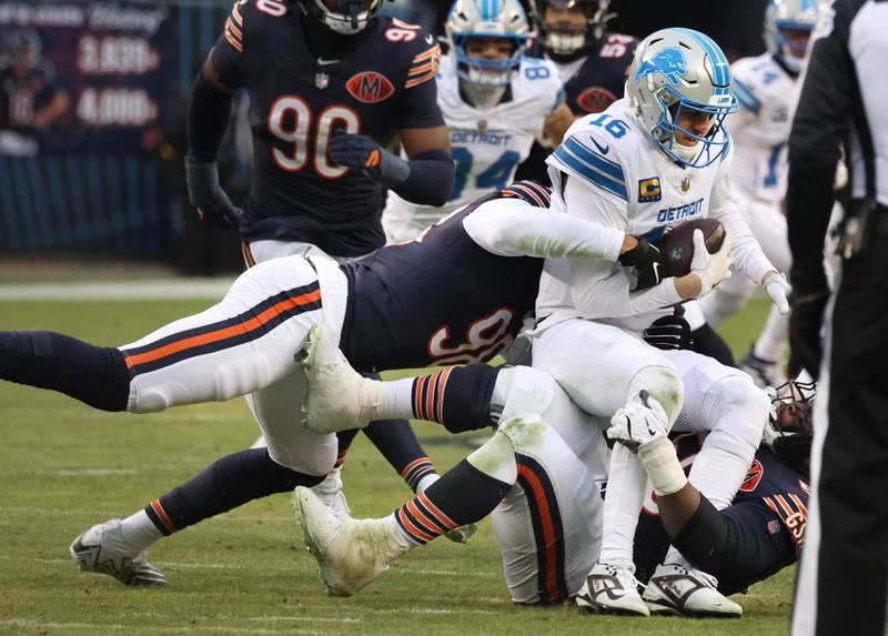 Chicago Bears defensive end Montez Sweat (left) and defensive end Grady Jarrett sack Detroit Lions quarterback Jared Goff during their game Sunday, Jan. 4, 2026, at Soldier Field in Chicago.