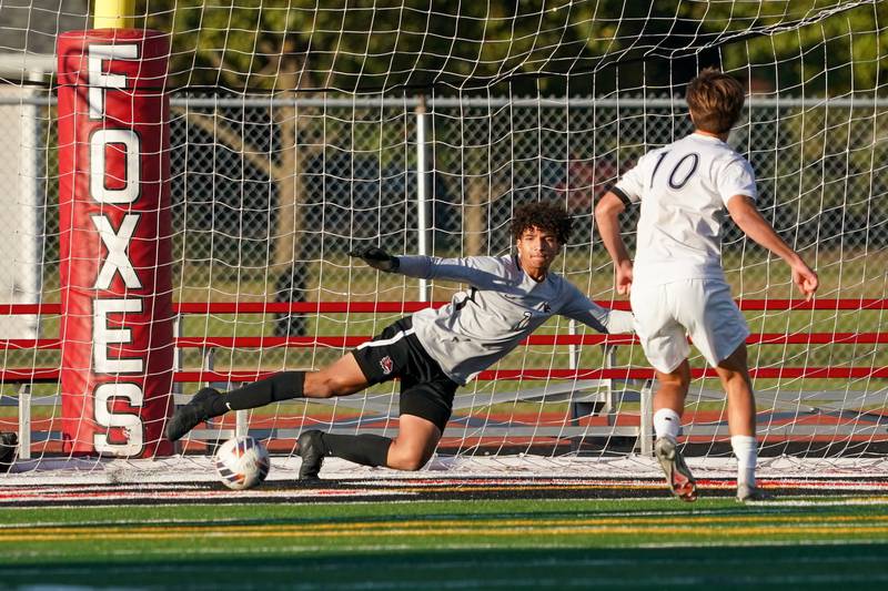 Oswego East's Dylan Drendel (10) shoots the ball past Yorkville's Caleb Reveter (1) for a goal on a penalty kick during a soccer match at Yorkville High School on Tuesday, Oct. 15, 2024.