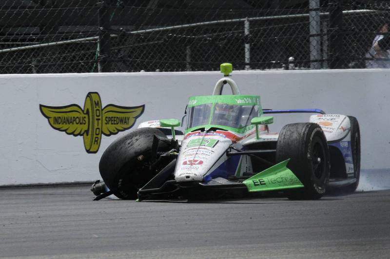Sting Ray Robb slides down the track after hitting the wall in the first turn during the Indianapolis 500, Sunday, May 28, 2023, at Indianapolis Motor Speedway.