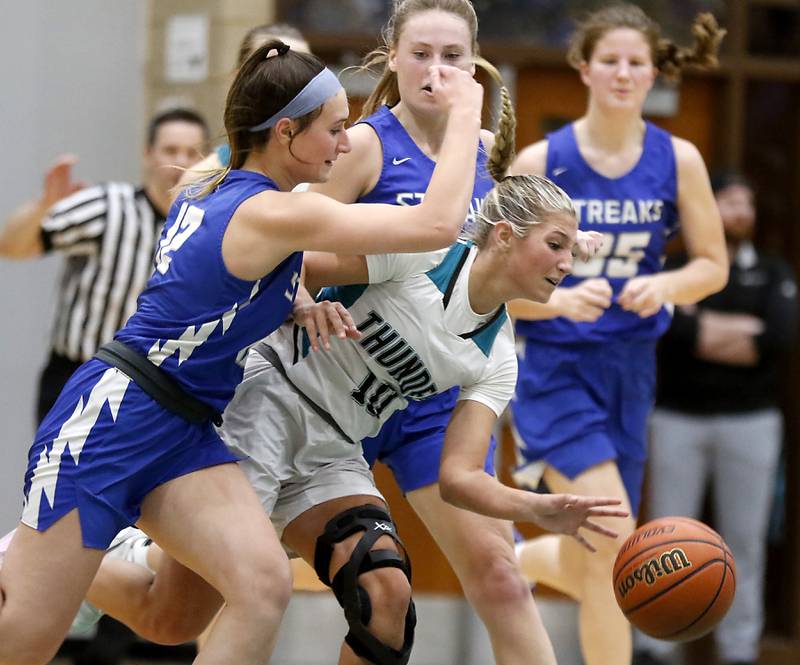 Woodstock North’s Addison Rishling pushes the ball up the court against Woodstock's Savannah Griffin (left) during a Kishwaukee River Conference girls basketball game on Friday, Jan. 5. 2024, at Woodstock North High School.
