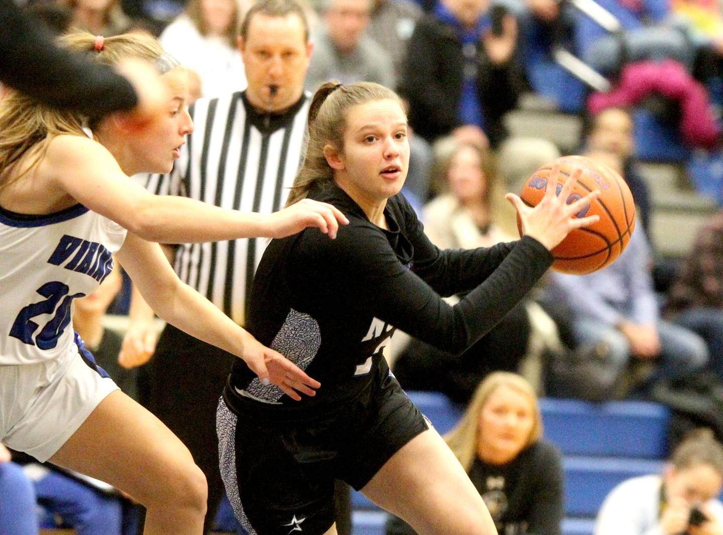 St. Charles North’s Alyssa Hughes (right) drives toward the basket during a game at Geneva on Friday, Dec. 9, 2022.