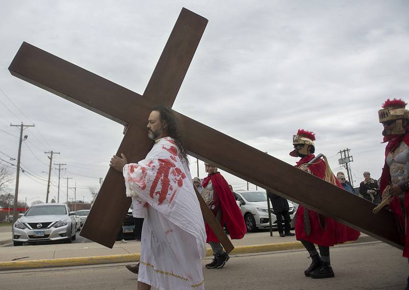 Felix Romo beings his journey playing the part of Jesus on Friday, April 15, 2022 during the retelling of the “stations of the cross” by St. Mary’s parish in Sterling.