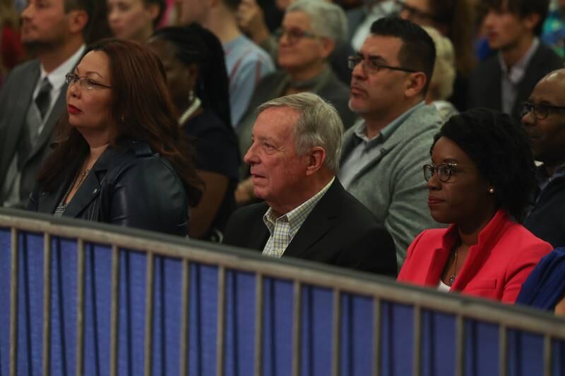 Senator Tammy Duckworth, left, Senator Dick Durbin and Congresswoman Lauren Underwood listens to President Joe Biden speak during his stop in Joliet at Jones Elementary School on Saturday.