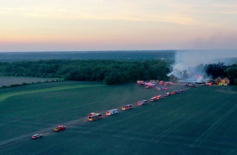 Fire trucks from Morris, Minooka, Plainfield, Braidwood and Wilmington travel to the scene of a five-alarm fire at Grand Bear Resort on Monday, May 30, 2022 in Utica.