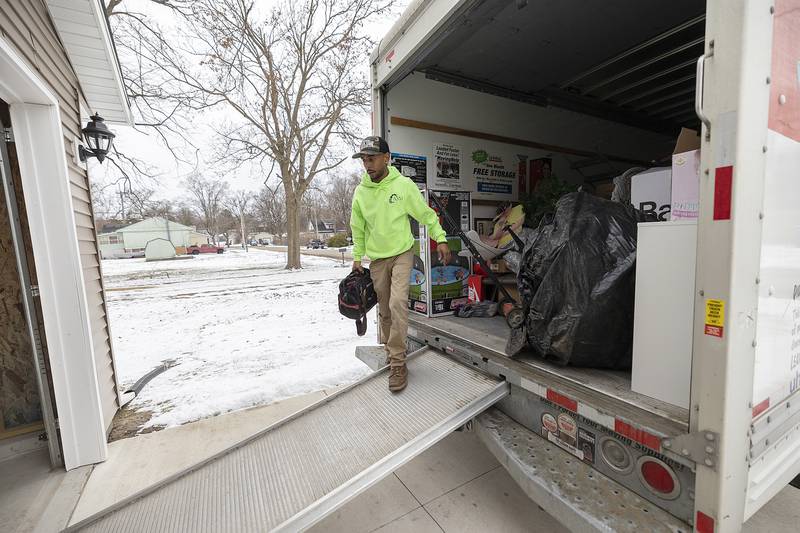 Tyler Stubblefield unloads items to his friend Megin Steeb’s new Habitat for Humanity home Sunday, Dec. 22, 2024, in Dixon.