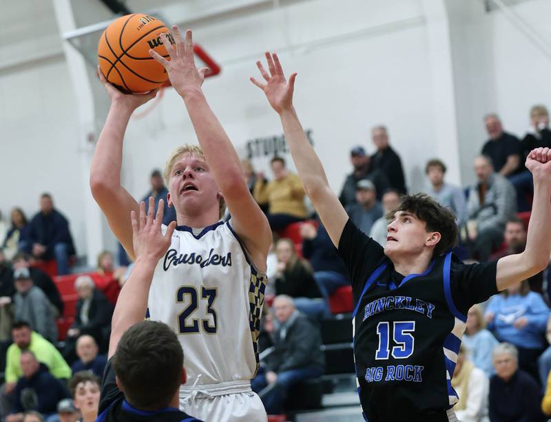 Marquette's Luke McCullough shoots between Hinckley-Big Rock's Austin Roop (left) and Gavin Pickert Tuesday, March 3, 2026, during their sectional semifinal matchup at Amboy High School.