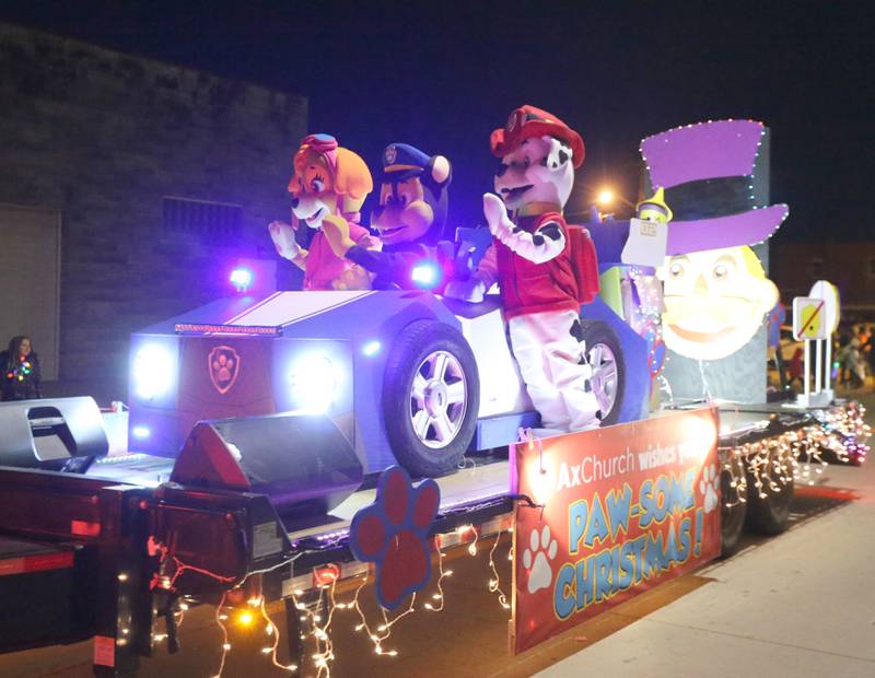 A light up Paw Patrol float put together by Ax Church rolls down Peoria Street during the Light up the Night parade on Saturday, Dec. 3, 2022 downtown Peru.