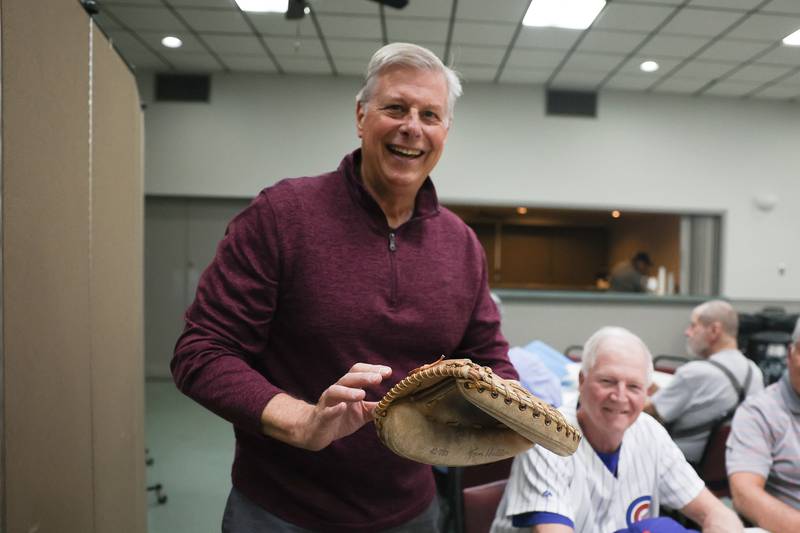 Mark Rauman, who played catcher at Lockport, poses with a Tom Haller catcher glove, a former MLB player and Lockport alumnus, at the Old Timers Baseball Association of Will County on Monday, April 15, 2024 in Joliet.