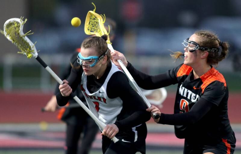 Huntley’s Aubrie Rohrbacher, left, battles Crystal Lake Central’s Fiona Lemke in varsity lacrosse at Huntley Wednesday.