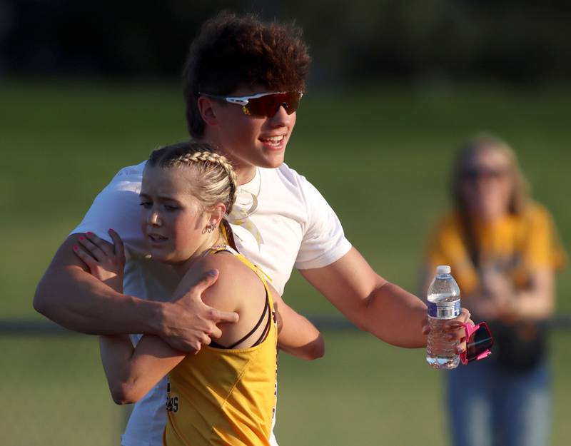 Jacobs’ Hudson Szymonik is greeted at the finish line after winning the 3200-meter run  in IHSA Class 3A Girls Sectional Track and Field Meet action at Red Raider Stadium on the campus of Huntley High School in Huntley on Wednesday, May 14, 2025.