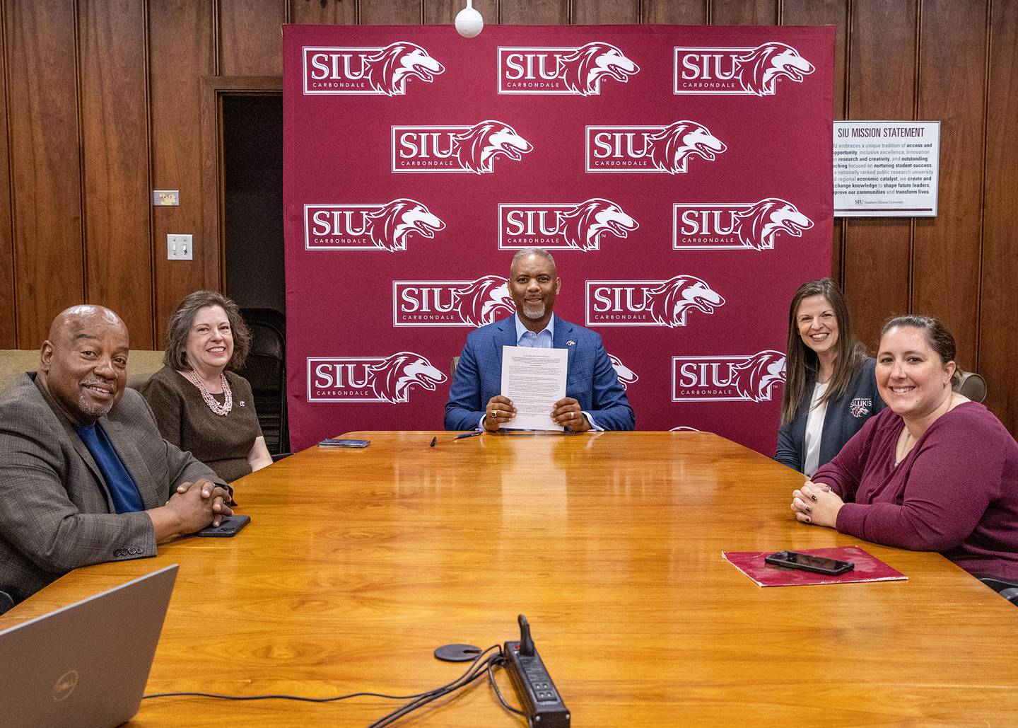 Southern Illinois University Chancellor Austin Lane (middle) signs the Saluki Step Ahead agreement with Illinois Valley Community College during a virtual ceremony Wednesday, May 8, 2024, with (from left) Wendell Williams, associate vice chancellor for enrollment management; Sheryl Tucker, provost and vice chancellor for academic affairs; Sarah Jiter, director of undergraduate admissions; and Josi Rawls, associate director for transfer relations.