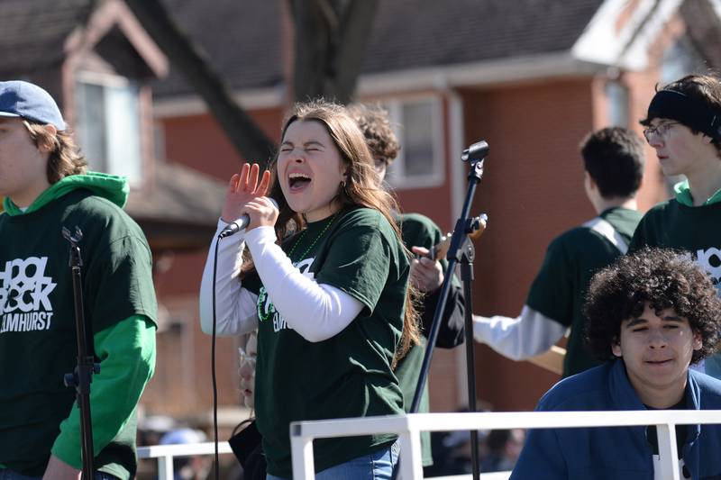 Elmhurst School of Rock vocalist Ava Mackay of Elmhurst sings "Gloria" while participating in the Elmhurst St. Patrick's Day Parade Saturday, March 9, 2024.