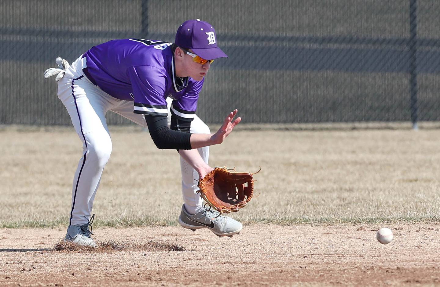 Dixon's Quade Richards fields a grounder during their game against DeKalb Tuesday, March 28, 2023, at DeKalb High School.