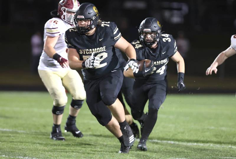 Sycamore's Joey Puleo follows Lincoln Cooley through the Morris line during their game Friday, Oct. 21, 2022, at Sycamore High School.