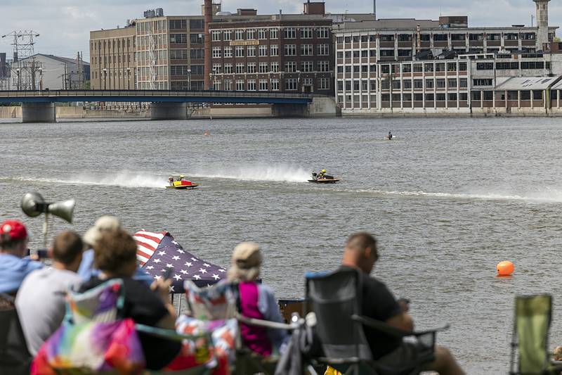 Racers zip across the Rock River on Saturday, Aug. 17, 2024, as fans watch from Seward's Park in Rock Falls. Thirty-seven drivers took to the water this weekend for the annual boat racing show.