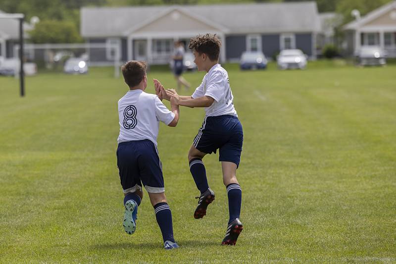 Sterling United Adlai Hilty (left) and Landon Camacho celebrate a goal against the Quad City Strikers Sunday, May 19, 2024 at Scheid Park in Sterling.