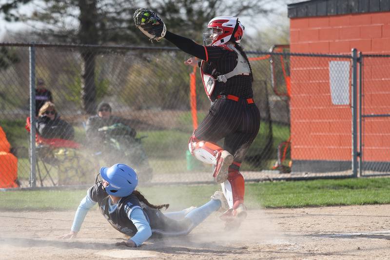 Minooka’s Ava Knutsen shows the umpire she held onto the ball after tagging out the Joliet Catholic runner on Tuesday, April 7, 2026 in Minooka.