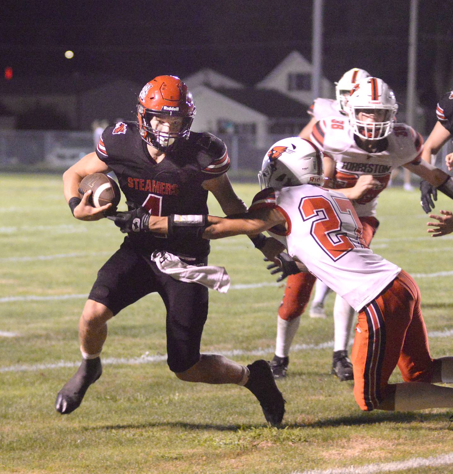 Fulton quarterback Dom Kramer fights off Forreston defenders during Friday, Aug. 30, 2024 action at Fulton High School. The Steamers won the game 28-0.