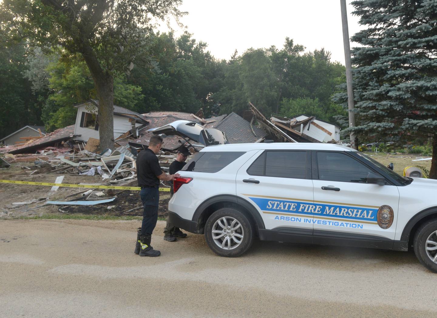 State Fire Marshal investigators retrieve equipment from their vehicle Friday evening in the 9000 block of East High Road, Stillman Valley, where a home was leveled in an explosion.