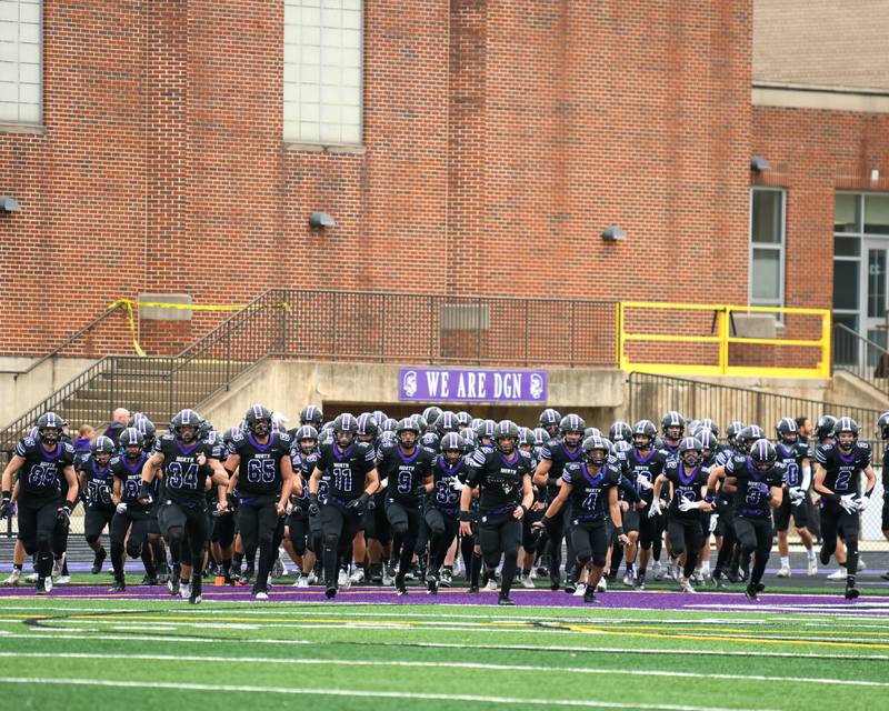 Downers Grove North’s football team takes the field before the start of the second week of the class 7A game on Saturday Nov. 9, 2024, while taking on Fenwick High School held at Downers Grove North High School.