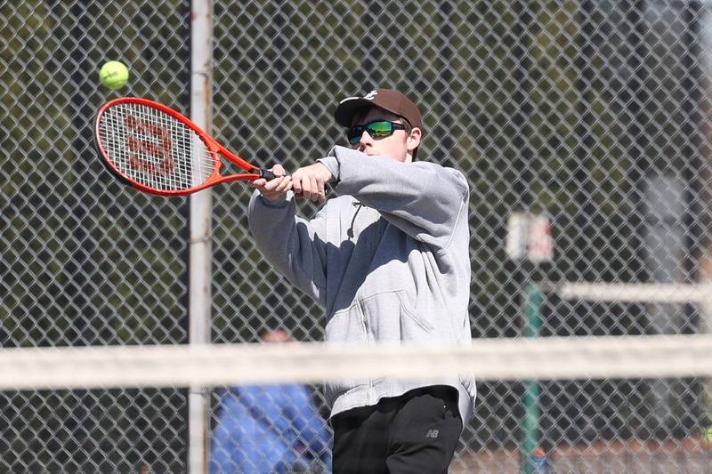 Joliet Catholic’s Thomas Dvorak returns a shot against Joliet Township’s Aaron Strong on Saturday, April 6, 2024 in Joliet.