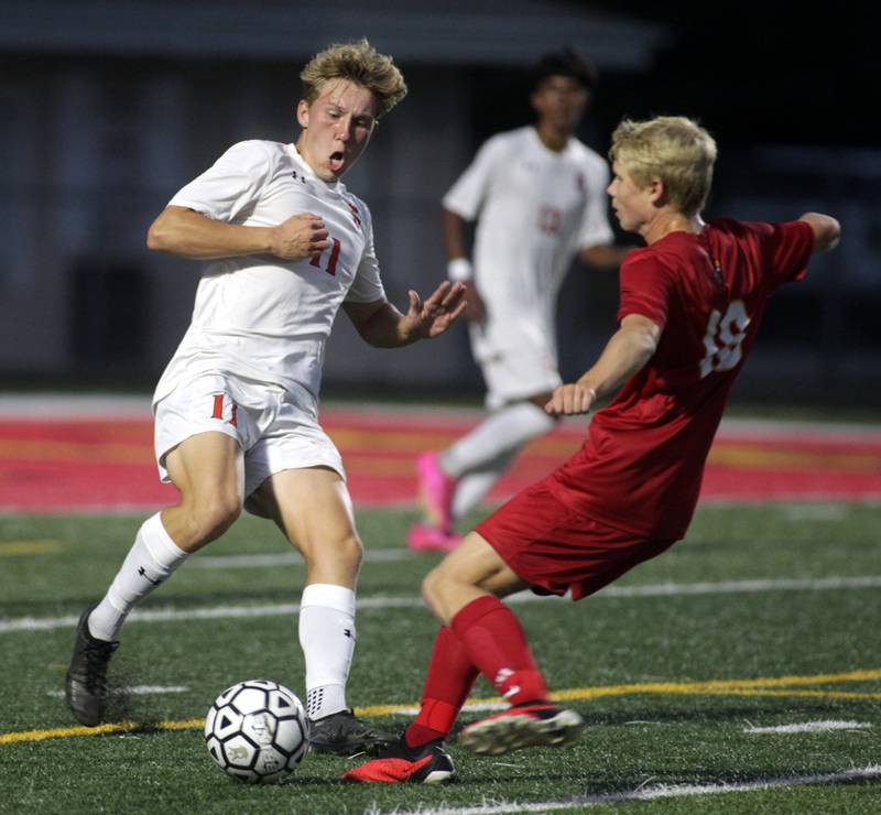 Oswego’s Nolan Gustafson (left) attacks the ball during a game at Batavia on Thursday, Sept. 7, 2023.