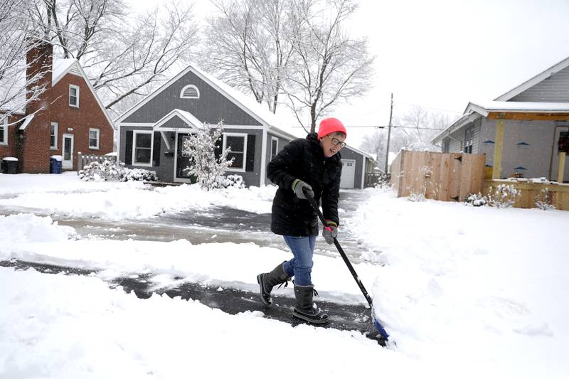 Karen (KK) King shovels her St. Charles driveway on Wednesday, Jan. 25, 2023.