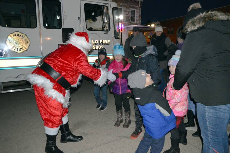 Santa Claus greets youngsters after arriving in downtown Polo on Dec. 3 to hear their wish lists and enjoy the fourth annual Polo Christmas Festival.