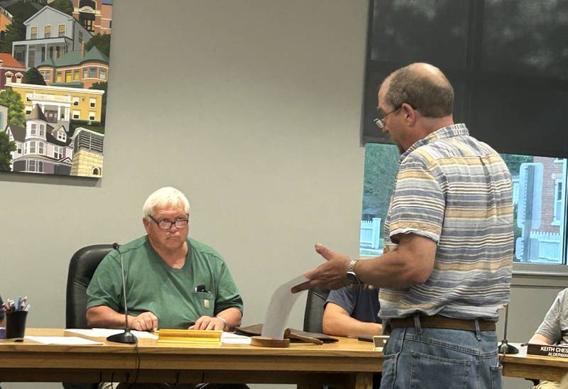 Polo Area Community Theatre board member Hart DuBois, (right)  talks to Buffalo Township Trustee Rich Faivre during a presentation of PACT's plan for taking ownership of the old Town Hall on Wednesday, May 14, 2025. The township voted 4-1 to donate the old Town Hall to the not-for-profit theater group.