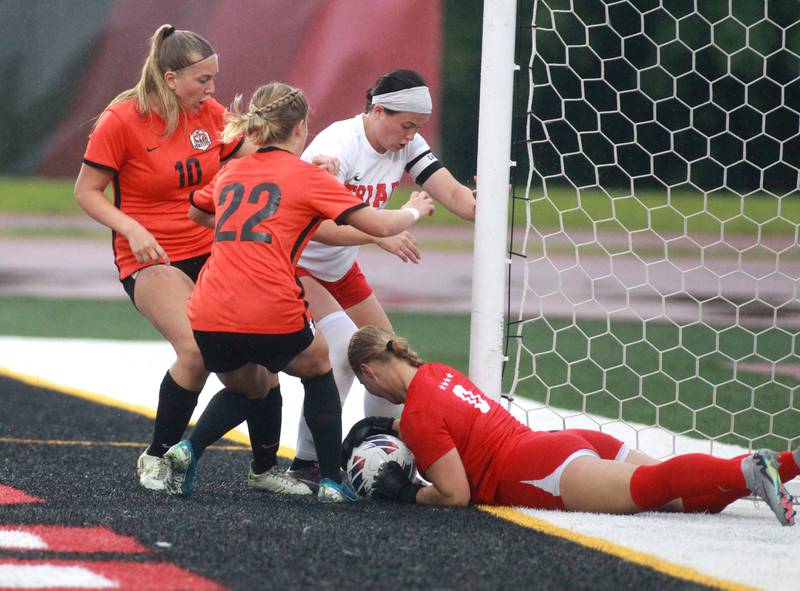 (Left to right) Crystal Lake Central’s Brooklynn Carlson and Olivia Anderson attempt a goal past Triad’s Hannah Sparks and goal keeper Payton Hartmann during the Class 2A state championship game at North Central College in Naperville on Saturday, June 1, 2024.