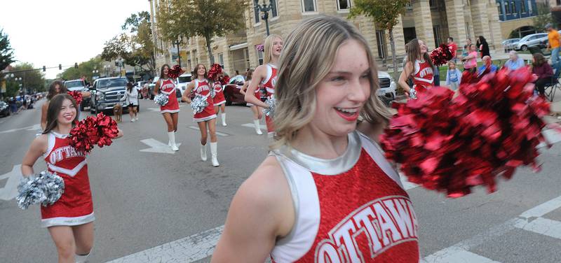 Ottawa High Cheerleaders march down LaSalle St in Ottawa Wednesday evening during the school’s annual Homecoming Parade.
