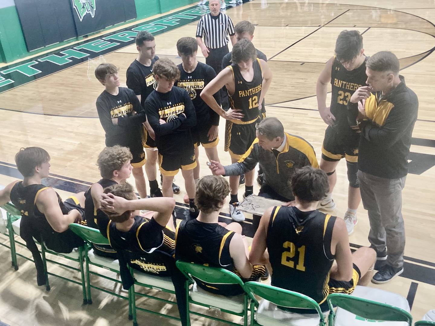 PC coach Harold Fay instructs his team during a timeout during Wednesday's game with Bureau Valley. The Storm won 50-38.