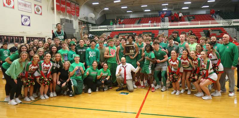 Members of the L-P boys basketball team, cheerleaders and super fans pose with the Class 3A Regional title plaque after defeating Streator on Friday, Feb. 28, 2025 in Sellett Gymnasium at L-P High School.