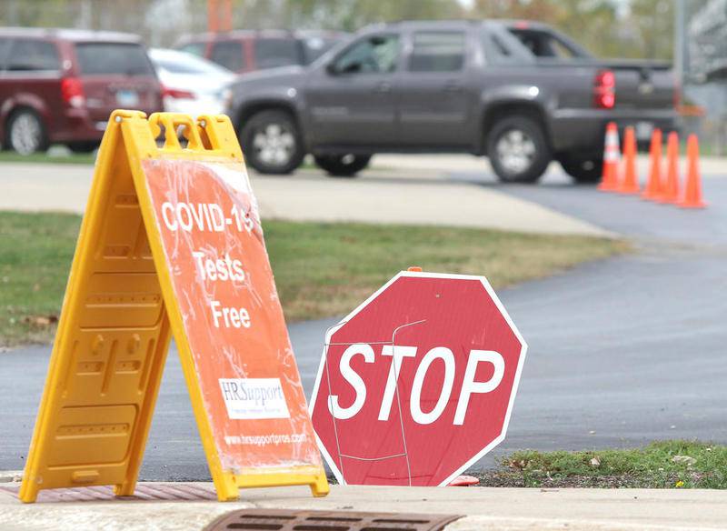 Vehicles line up at the free drive-thru COVID-19 testing site at DeKalb High School Tuesday morning. The testing by HR Support is offered through a partnership of the Illinois Department of Public Health, the DeKalb County Health Department and DeKalb Community School District 428.