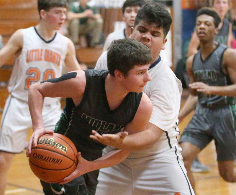 Midland's Quin Gauwitz looks to pass the ball as DePue's Ramon Arevalo defends on Monday, Dec. 19, 2022 at DePue High School.