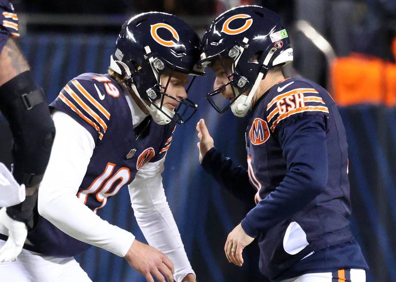 Chicago Bears place kicker Cairo Santos (right) gets a headbut from his holder punter Tory Taylor after kicking a late field goal Saturday, December 20, 2025, during their game against the Green Bay Packers at Soldier Field in Chicago.