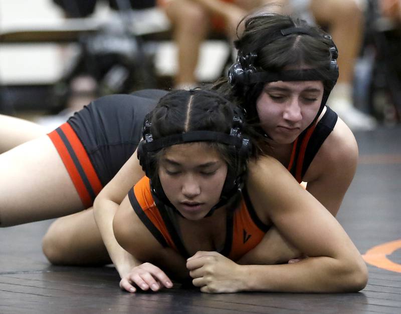 Huntley’s Valaria Sanchez controls McHenry’s Bianca Mangalindan during the 115-pound match of a Fox Valley Conference girls wrestling match Thursday, Jan. 11, 2024, at McHenry High School.