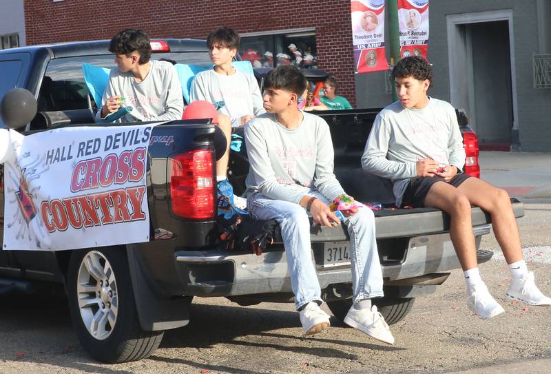 The Hall High School cross country team rides during the Homecoming parade on Thursday, Sept. 18, 2025 downtown Spring Valley.