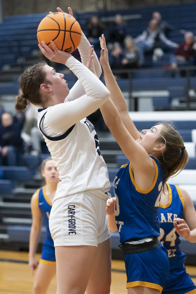 Cary-Grove's Ellie Mjaanes shoots over Lake Forest's Charlotte Axus during the Class 3A Cary-Grove Regional Girls Basketball Championship game on Thursday, February 20, 2025 in Cary. Ryan Rayburn for Shaw Local