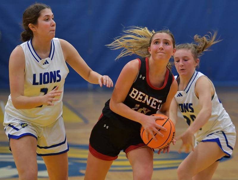 Benet's Lindsay Harzich (middle) drives past Lyons Township's Taylor Carroll (left) and Avery Mezan during a game on November 19, 2024 at Lyons Township High School in LaGrange.
