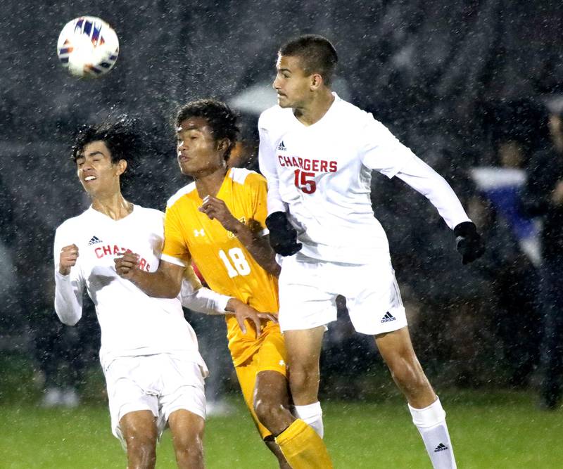 Dundee-Crown’s Miguel Pena (left) and Daniel Gantz (right) battle Jacobs’ LZ McIntosh in boys soccer at Algonquin on Tuesday, Oct. 11, 2022.