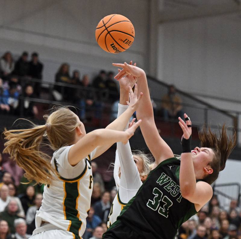 Fremd’s Coco Urlacher, left, draws a foul on a shot by Glenbard West's Mya Austin during the Hersey Class 4A supersectional at Forest View Education Center on Monday, March 3, 2025 in Arlington Heights.