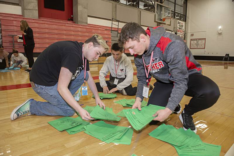 Erie-Prophetstown students Ryan Roman (left), Ben Lantz and Connor Sibley race through paperwork during an activity at SVCC’s Education Symposium Friday, April 29, 2022. The symposium was aimed at high school students looking to go into the field of teaching.