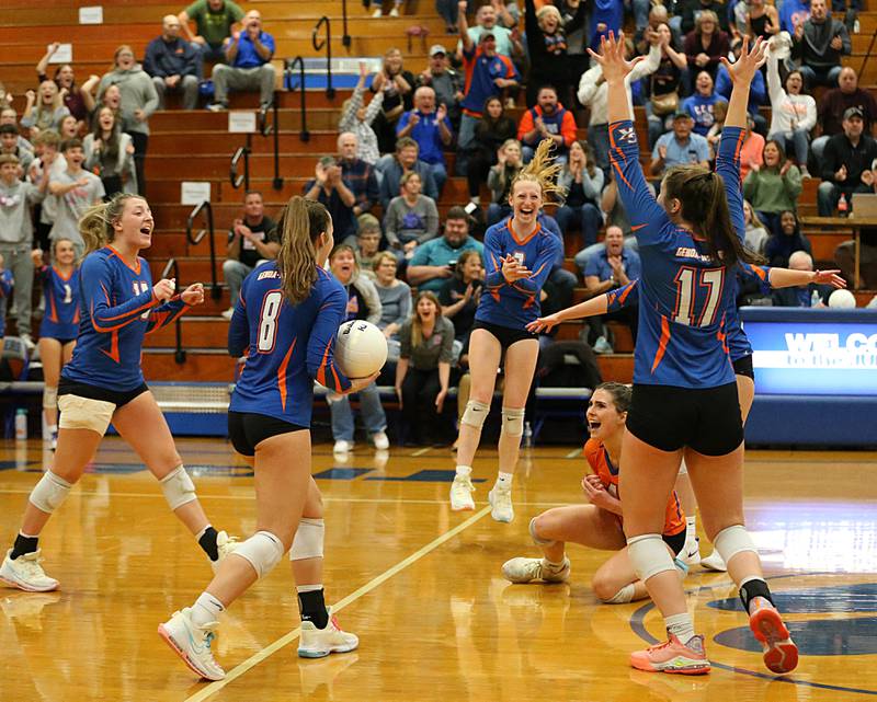 Members of the Genoa-Kingston volleyball team react after defeating Quincy Notre Dame in three sets in the Class 2A Supersectional game on Friday, Nov. 4, 2022 at Princeton High School.