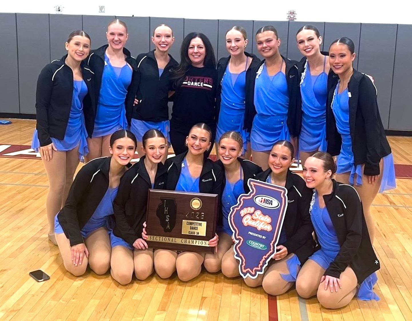 The Lockport competitive dance team captured the Champaign Central Sectional championship and advanced to the IHSA State Meet to be held this coming weekend in Bloomington. Lockport took the Class 3A title scoring 91.60 points, over three points better than runner-up and fellow state qualifier Lincoln-Way West. Lincoln-Way Central, Minooka and Plainfield North also advanced out of the sectional. Pictured with their sectional championship plaque is Lockport (left to right): in front – Samantha Arroyo, Livvy Lonergan, Kennidie Byrdak, Emmersyn Arroyo, Kara Kinney and Kate Depcik; and standing – Ireland Roberson, Sydney Cline, Ella Lonergan, coach Gina Miranda, Mia Koenig, Sloan Moore, Grace Wedewer and Alice Daley.
