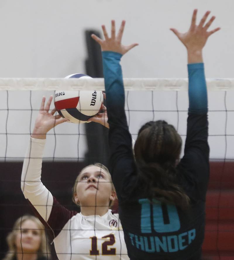 Richmond-Burton's Zoe Freund sets the ball in front of Woodstock North's Ava Kardaras during a Kishwaukee River Conference volleyball match on Wednesday, Oct. 15, 2025, at the Richmond-Burton High School in Richmond.
