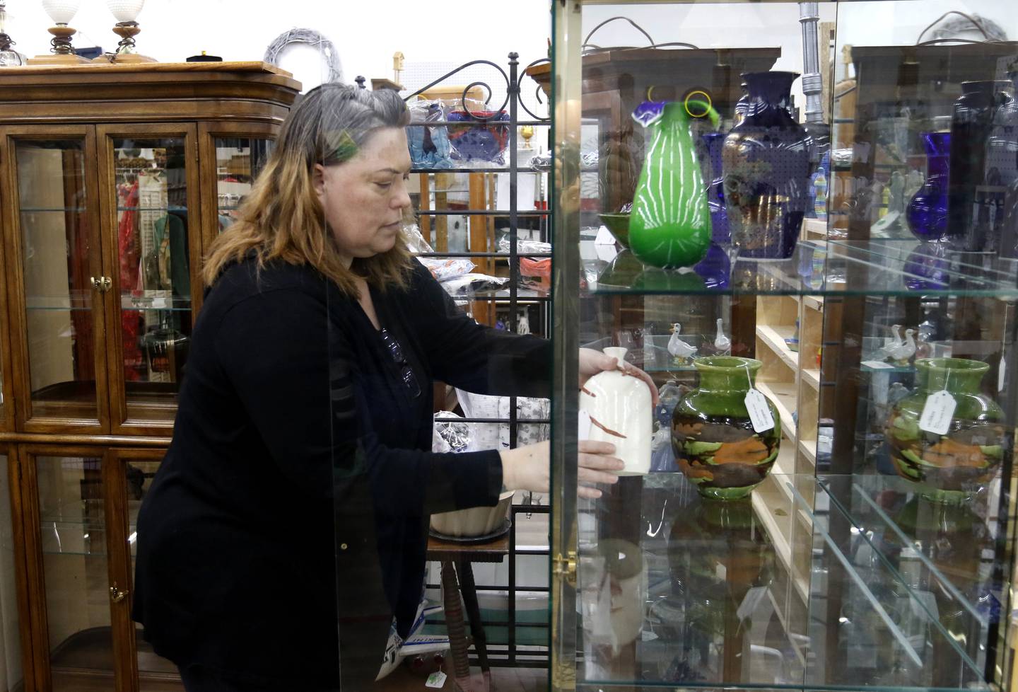 Mandi Graf, of the D&M Finds booth in Q'Tiques in McHenry works on preparing Q'Tiques and her booth on Tuesday, March 4, 2025, for this weekend's Shop Hop. More than 300 vintage and antique shops are participating in Shop Hop Weekend in Wisconsin and Illinois.
